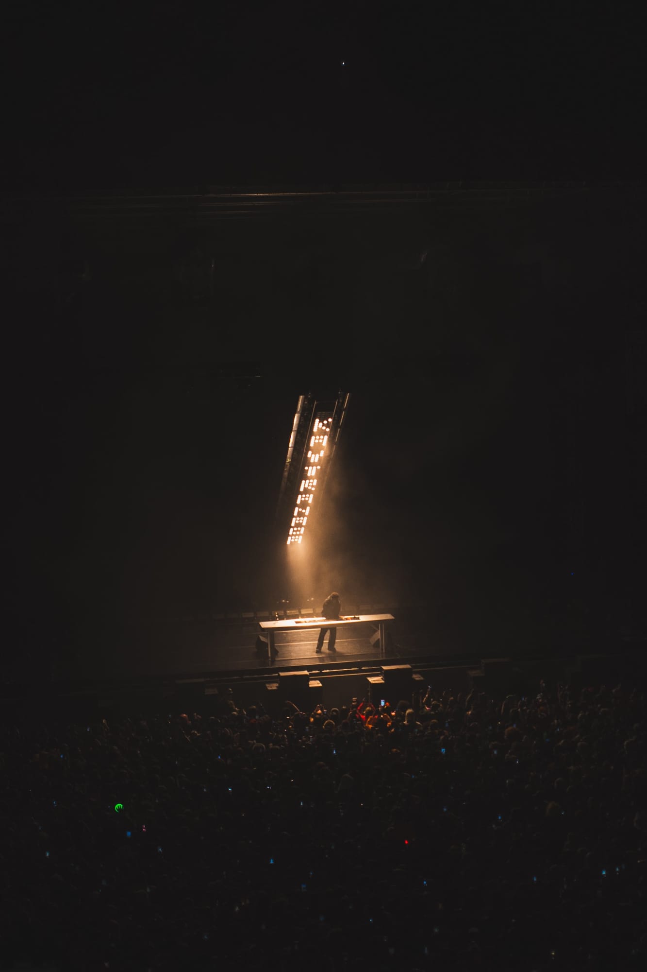 Stage lights over a crowd at a night concert