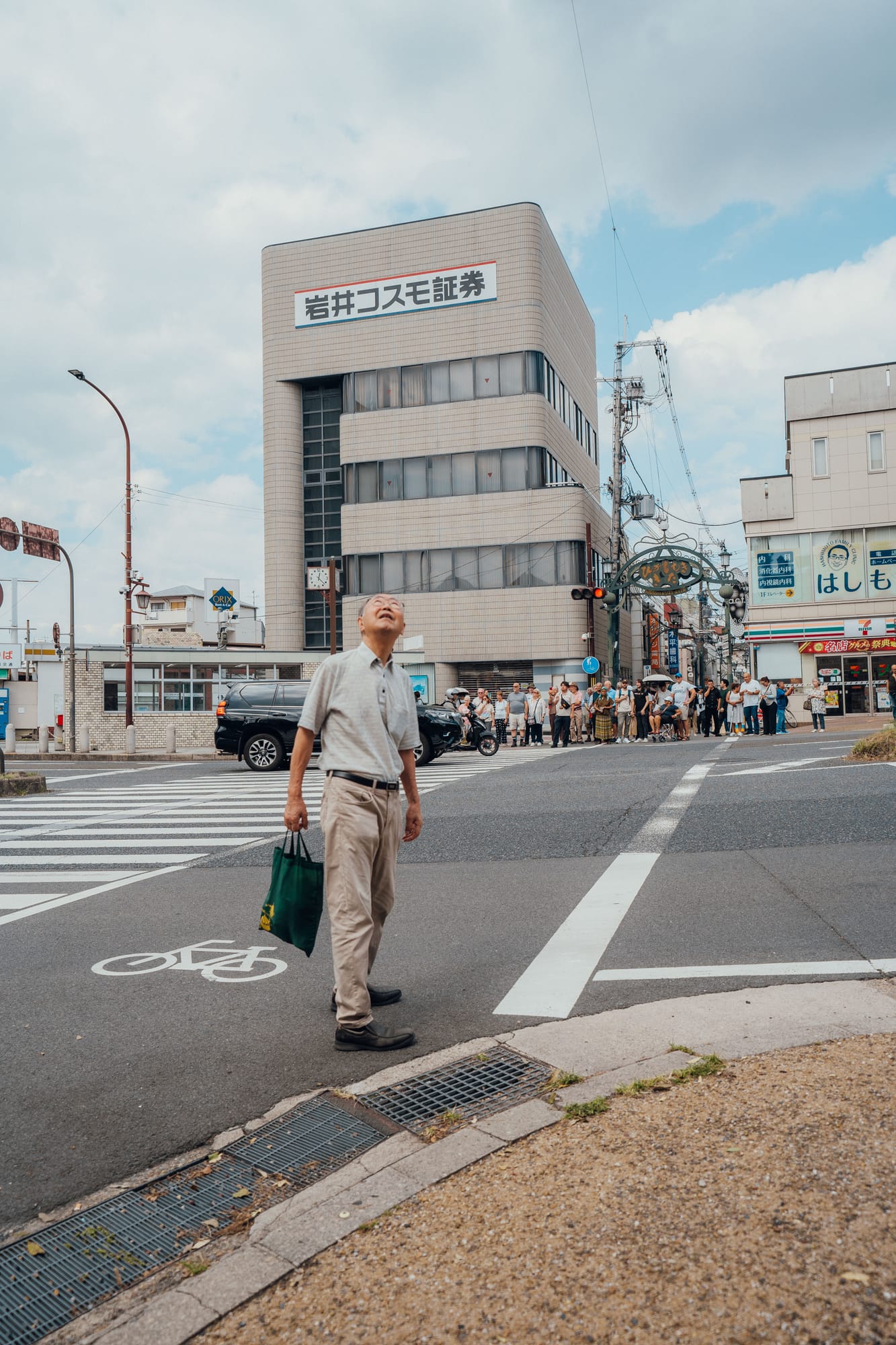 Man crossing a quiet street in a Japanese town