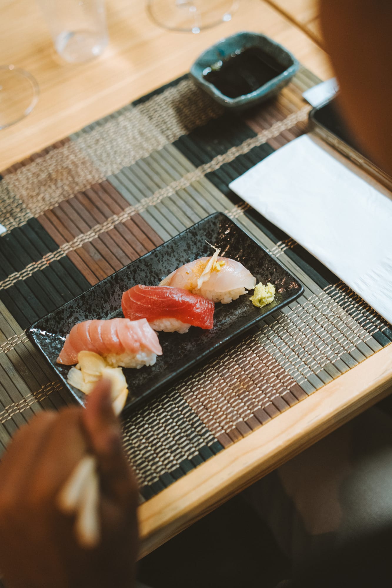 Nigiri on a stone plate at an omakase counter