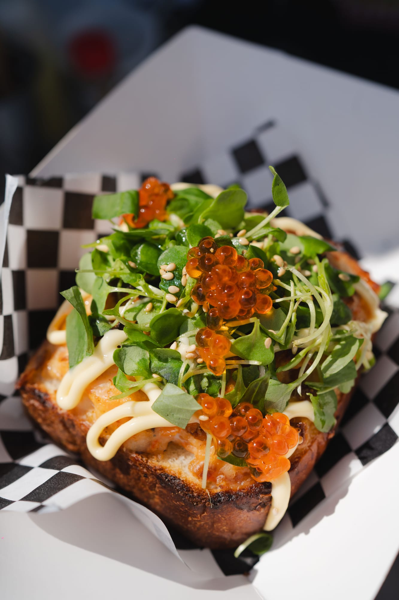 Salmon toast piled with greens and roe